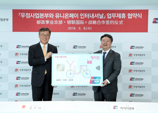 강성주 우정사업본부 본부장(왼쪽)과 차이지앤뽀 유니온페이 인터내셔날 총재가 해외 카드 결제사업 상호협력을 위한 업무협약을 8일 서울중앙우체국에서 체결하고 기념 촬영을 하고 있다. 우정사업본부 제공